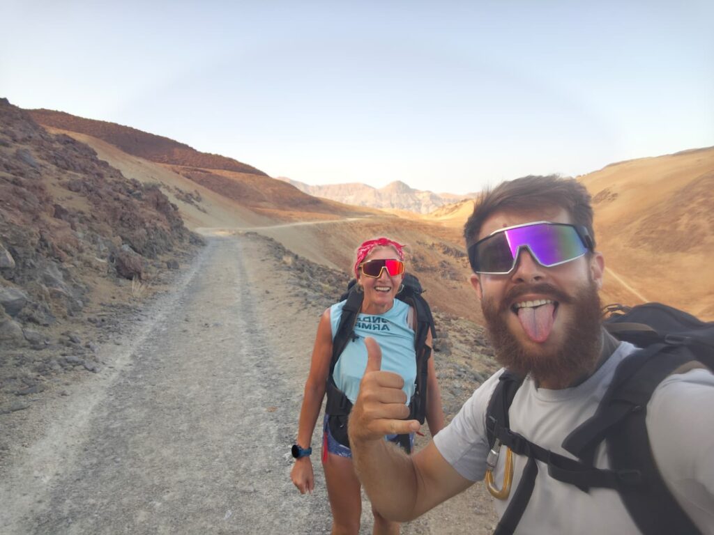 Two hikers taking a selfie on the gravel track of the Teide trail near Montaña Blanca