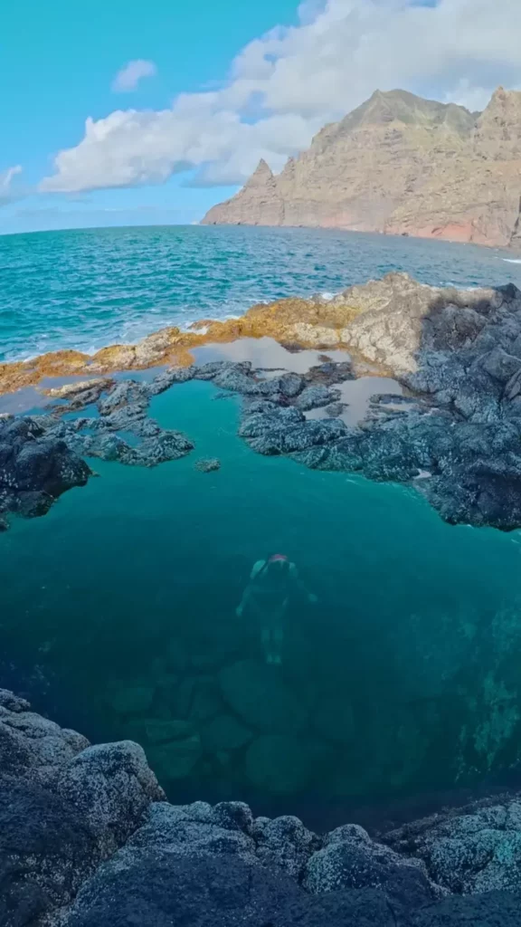 Swimmer in a natural lava pool on the north coast of Tenerife